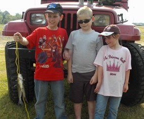 Fishing Team Holds up Their Fish for the Camera